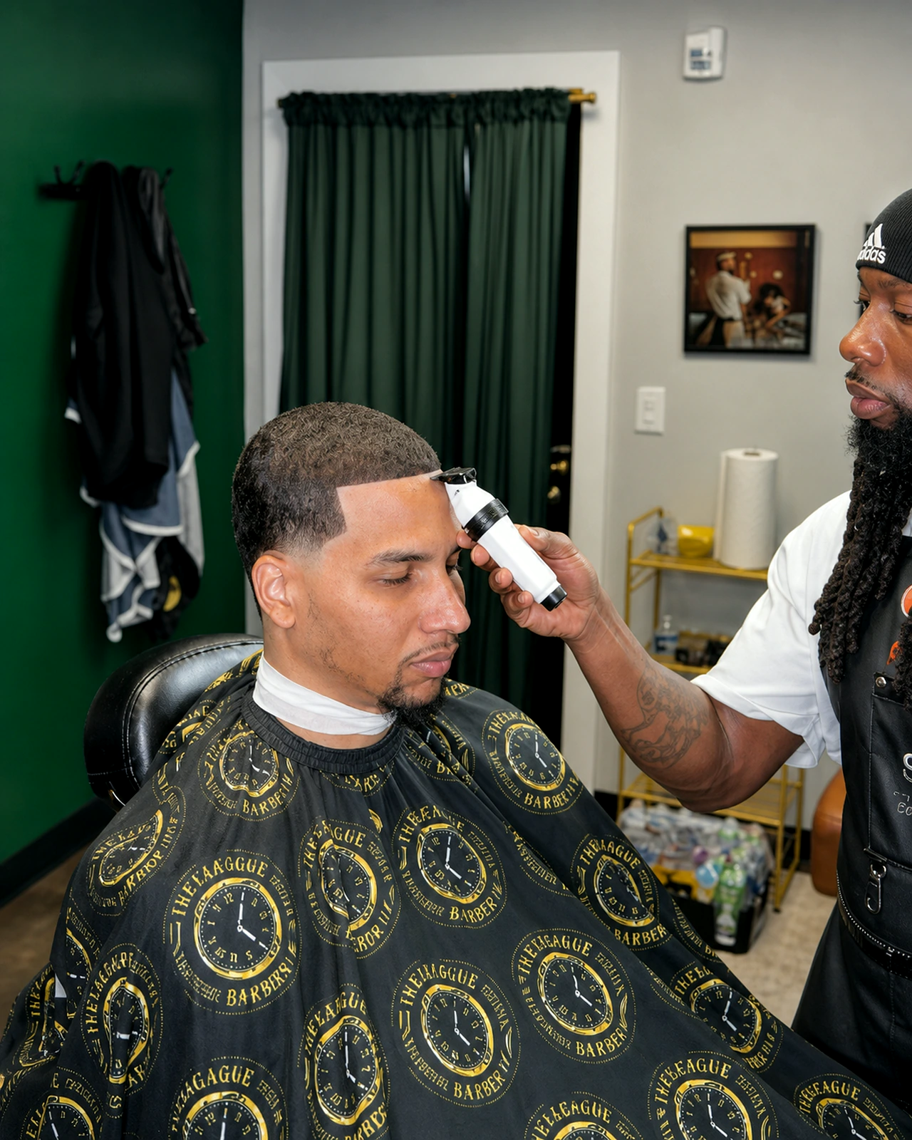 Ivey League Barber shaping a client's hairline during the cut